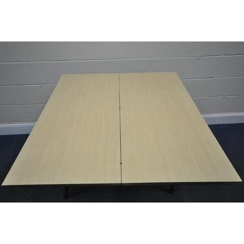 183 - A SCANDINAVIAN STYLE FORMICA TOP FOLD OVER TABLE, the top swivels revealing a storage section, raise... 