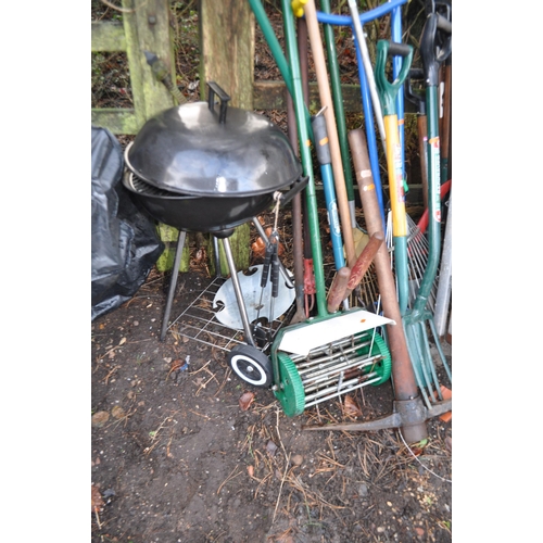 14 - A SELECTION OF GARDEN TOOLS AND A BARBECUE including step ladders, rakes, forks,  lawn seeder, a bir... 