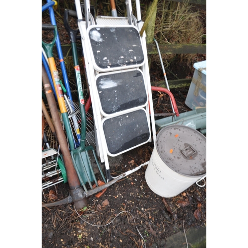 14 - A SELECTION OF GARDEN TOOLS AND A BARBECUE including step ladders, rakes, forks,  lawn seeder, a bir... 