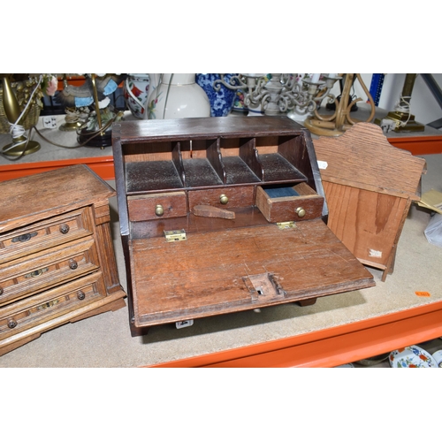 834 - A MINIATURE WRITING BUREAU AND TWO MINIATURE SETS OF DRAWERS comprising a wooden miniature bureau wi... 