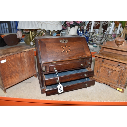 834 - A MINIATURE WRITING BUREAU AND TWO MINIATURE SETS OF DRAWERS comprising a wooden miniature bureau wi... 