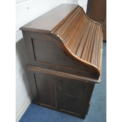 153 - A 20TH CENTURY OAK TAMBOUR FRONT DESK, with a fitted interior, raised on twin pedestals, each with a... 