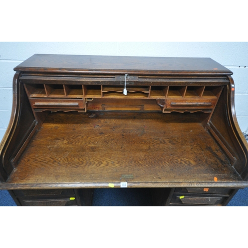 153 - A 20TH CENTURY OAK TAMBOUR FRONT DESK, with a fitted interior, raised on twin pedestals, each with a... 