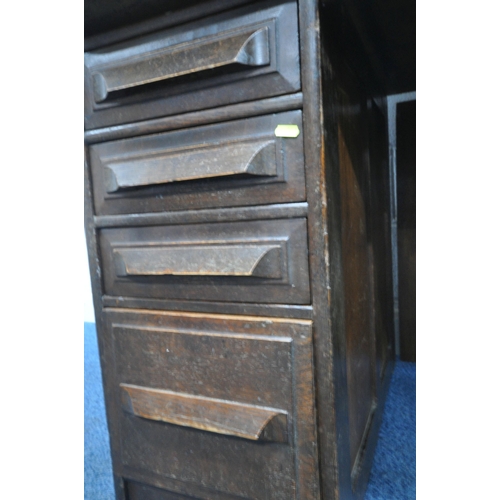 153 - A 20TH CENTURY OAK TAMBOUR FRONT DESK, with a fitted interior, raised on twin pedestals, each with a... 