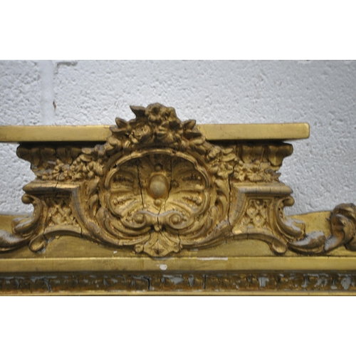 157 - A RECTANGULAR GILT FRAME BEVELLED EDGE OVERMANTEL MIRROR, with a scrolled crest, foliate swags, and ... 