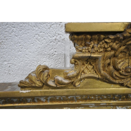 157 - A RECTANGULAR GILT FRAME BEVELLED EDGE OVERMANTEL MIRROR, with a scrolled crest, foliate swags, and ... 