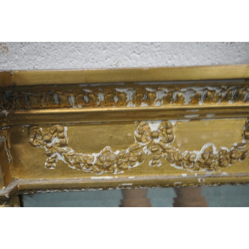 157 - A RECTANGULAR GILT FRAME BEVELLED EDGE OVERMANTEL MIRROR, with a scrolled crest, foliate swags, and ... 