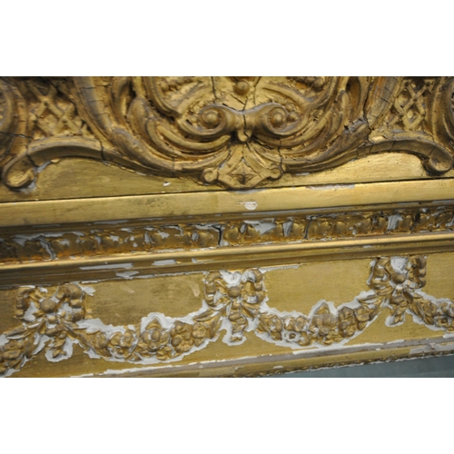 157 - A RECTANGULAR GILT FRAME BEVELLED EDGE OVERMANTEL MIRROR, with a scrolled crest, foliate swags, and ... 