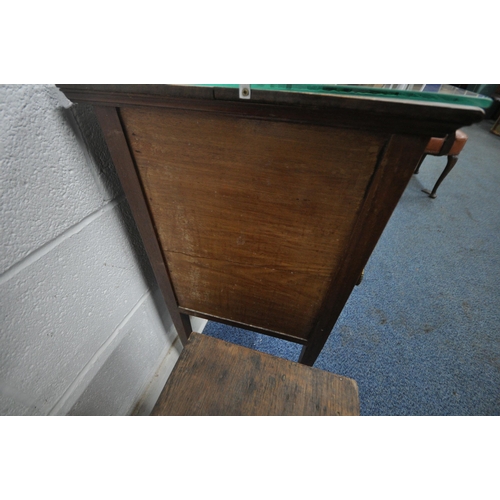 180 - A 20TH CENTURY OAK WALL HANGING SHELF, with two lead glazed doors, flanking a bevelled edge mirror, ... 