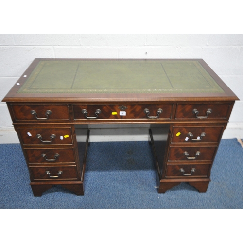 187 - A 20TH CENTURY MAHOGANY TWIN PEDESTAL DESK, with a green leather writing surface, fitted with nine a... 