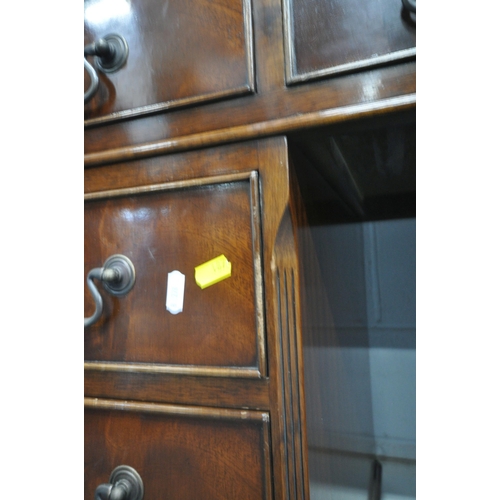 187 - A 20TH CENTURY MAHOGANY TWIN PEDESTAL DESK, with a green leather writing surface, fitted with nine a... 