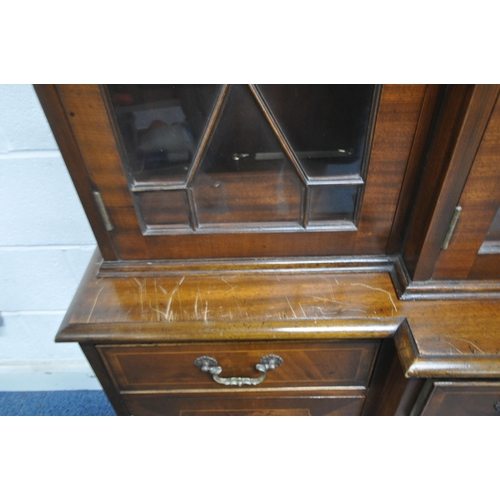 198 - A LATE 20TH CENTURY MAHOGANY BREAKFRONT BOOKCASE, fitted with four glazed doors, atop a base with th... 