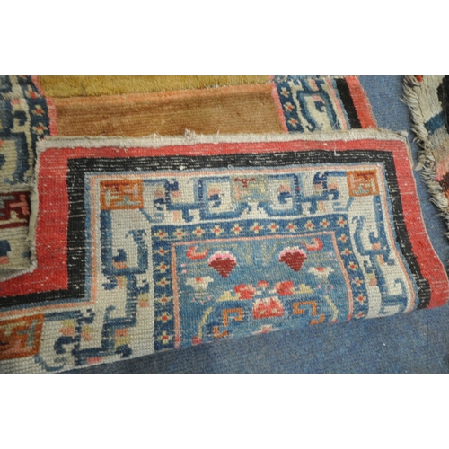 199 - A TIBETAN RECTANGULAR RUG, depicting two dragons, black field, and a multi-coloured border, 139cm x ... 