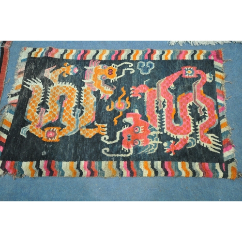 199 - A TIBETAN RECTANGULAR RUG, depicting two dragons, black field, and a multi-coloured border, 139cm x ... 