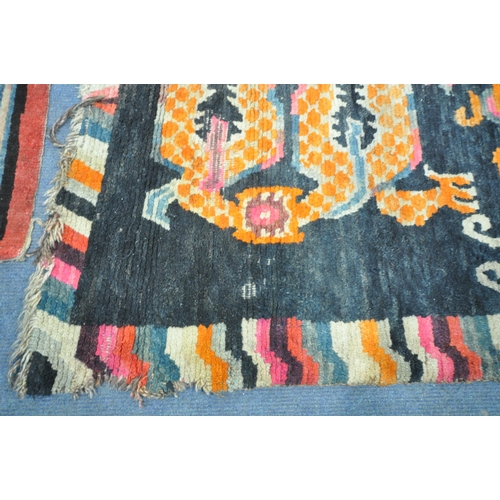 199 - A TIBETAN RECTANGULAR RUG, depicting two dragons, black field, and a multi-coloured border, 139cm x ... 