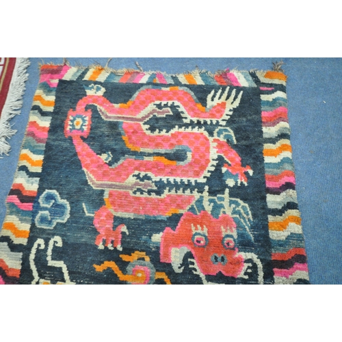 199 - A TIBETAN RECTANGULAR RUG, depicting two dragons, black field, and a multi-coloured border, 139cm x ... 