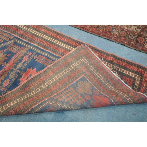 202 - TWO IRANIAN RED RUGS, both with repeating patterns, and a multi-strap border, largest 180cm x 106cm,... 