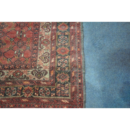 202 - TWO IRANIAN RED RUGS, both with repeating patterns, and a multi-strap border, largest 180cm x 106cm,... 