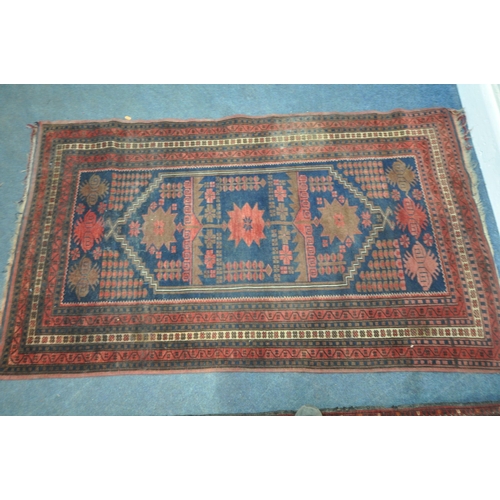 202 - TWO IRANIAN RED RUGS, both with repeating patterns, and a multi-strap border, largest 180cm x 106cm,... 