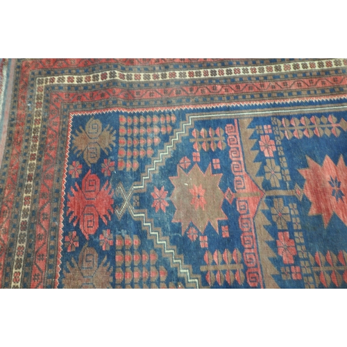 202 - TWO IRANIAN RED RUGS, both with repeating patterns, and a multi-strap border, largest 180cm x 106cm,... 