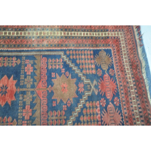 202 - TWO IRANIAN RED RUGS, both with repeating patterns, and a multi-strap border, largest 180cm x 106cm,... 