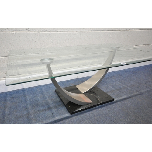 207 - A RECTANGULAR GLASS TOP COFFEE TABLE, raised on two shaped supports, length 127cm x depth 71cm x hei... 