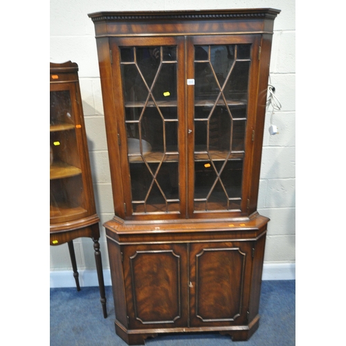 222 - A LATE 20TH CENTURY MAHOGANY CORNER CUPBOARD, fitted with double glazed doors, above double cupboard... 