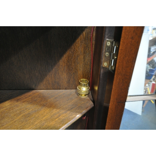 222 - A LATE 20TH CENTURY MAHOGANY CORNER CUPBOARD, fitted with double glazed doors, above double cupboard... 