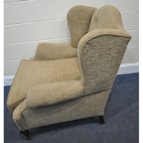 229 - AN OATMEAL WING BACK ARMCHAIR, with a deep seat, raised on front cabriole legs, width 88cm x depth 8... 