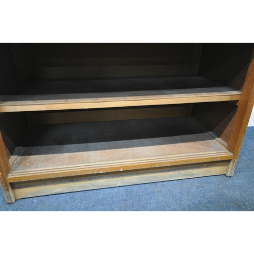 256 - A 20TH CENTURY OAK HABERDASHERY CABINET, fitted with sixteen glass fronted drawers, above a shelf, w... 