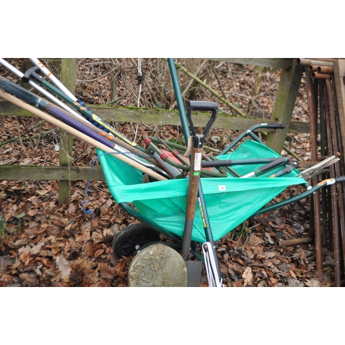 10 - A MODERN LEAF BARROW WITH TOOLS INSIDE, including a tree popper, kneeler, a wheel with tyre, etc