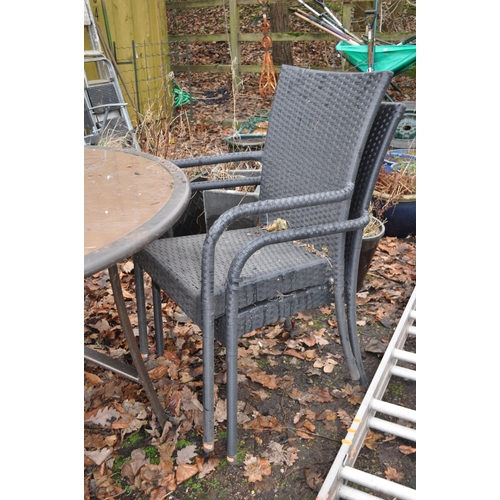 13 - A GLASS TOPED METAL FRAMED GARDEN TABLE diameter 110cm and four rattan style chairs (5)