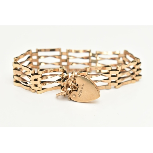 404 - A 9CT GOLD GATE BRACELET, four bar bracelet, approximate width 13.0mm, fitted with a heart padlock c... 