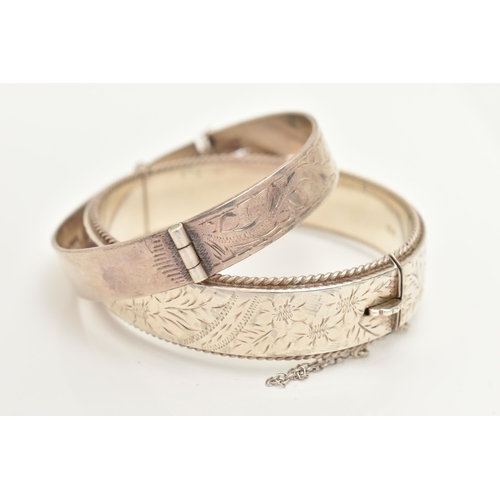 427 - TWO SILVER BANGLES, the first a hinged bangle with etched floral and rope detail, approximate width ... 