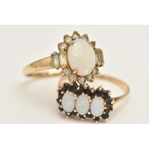 441 - TWO 9CT GOLD OPAL SET RINGS, the first an oval cluster ring set with an oval cut white opal cabochon... 