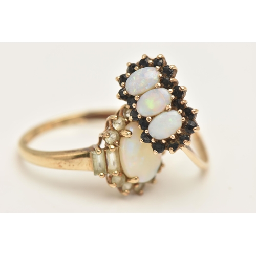 441 - TWO 9CT GOLD OPAL SET RINGS, the first an oval cluster ring set with an oval cut white opal cabochon... 