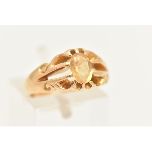 444 - A YELLOW METAL CITRINE SET RING, set with an oval cut Citrine, claw set to the scrolling openwork sh... 