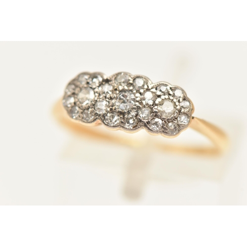 445 - A YELLOW METAL DIAMOND TRIPLE CLUSTER RING, designed as three flower clusters, each set with a singl... 