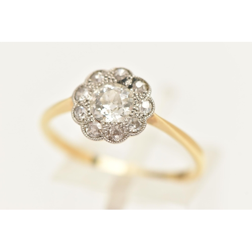 448 - A YELLOW METAL DIAMOND DAISY RING, centering on an old cut diamond, spreads approximately 0.50ct, wi... 