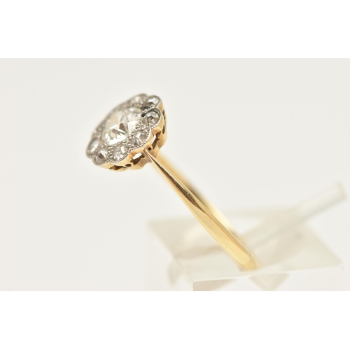 448 - A YELLOW METAL DIAMOND DAISY RING, centering on an old cut diamond, spreads approximately 0.50ct, wi... 