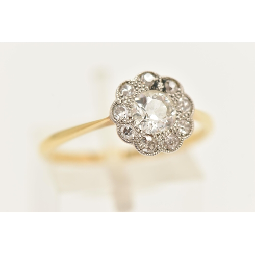 448 - A YELLOW METAL DIAMOND DAISY RING, centering on an old cut diamond, spreads approximately 0.50ct, wi... 