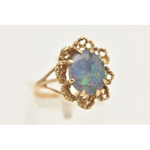 451 - A 9CT GOLD OPAL TRIPLET RING, set with an oval cut opal triplet, in an eight claw setting to the tex... 