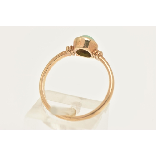 452 - A 9CT GOLD JADE RING, collet set with an oval cut green jade cabochon, to a polished band, hallmarke... 