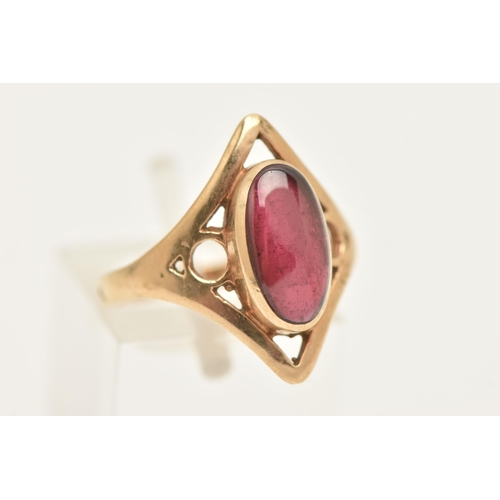 453 - A 9CT GOLD GARNET RING, collet set with an oval cut garnet, within an open work diamond shape mount ... 