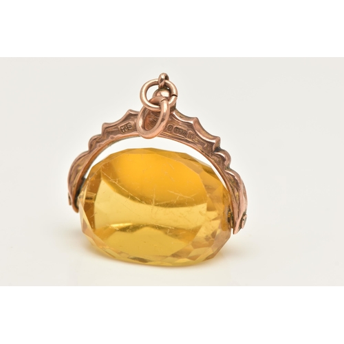 455 - AN EARLY 20TH CENTURY, 9CT GOLD SWIVEL FOB, set with a faceted yellow paste, fixed to a textured sur... 