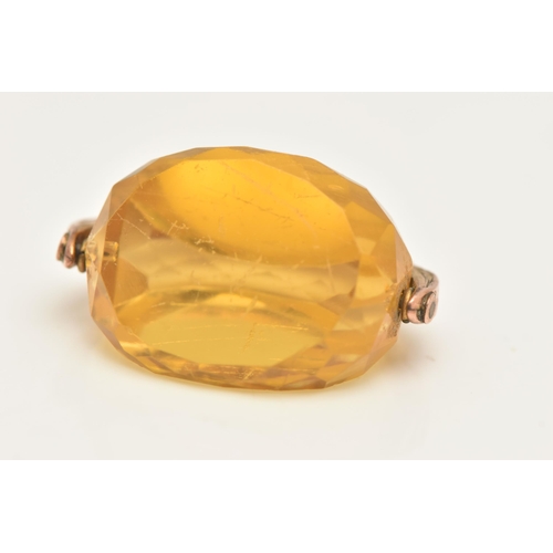 455 - AN EARLY 20TH CENTURY, 9CT GOLD SWIVEL FOB, set with a faceted yellow paste, fixed to a textured sur... 