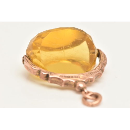 455 - AN EARLY 20TH CENTURY, 9CT GOLD SWIVEL FOB, set with a faceted yellow paste, fixed to a textured sur... 