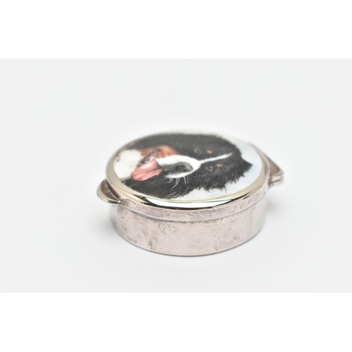 467 - A CIRCULAR SILVER ENAMEL PILL BOX, displaying a Burnese mountain dog to the hinged cover, black fabr... 