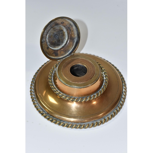 773 - A NINETEENTH CENTURY BRASS INKWELL, of circular form with rope style edging, and a Pietra dura flora... 