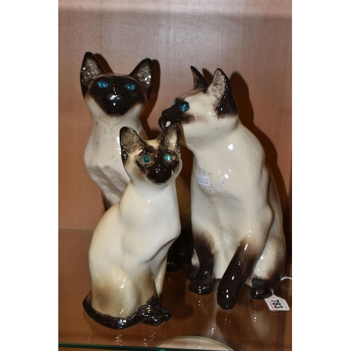 783 - THREE WINSTANLEY POTTERY SIAMESE CATS, comprising a seated cat T34, height 23cm (chipped left ear, a... 